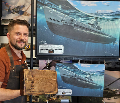 Artist, Craig Tinder, standing nextt to the "Silent Predator" canvas and holding the USS Atule relic.