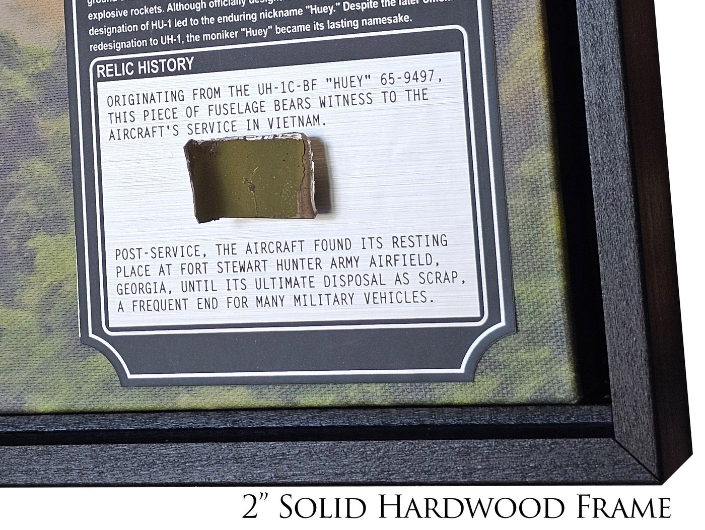 Detail shot of the 'Stacked Deck' UH-1C Huey helicopter art, focusing on the relic.